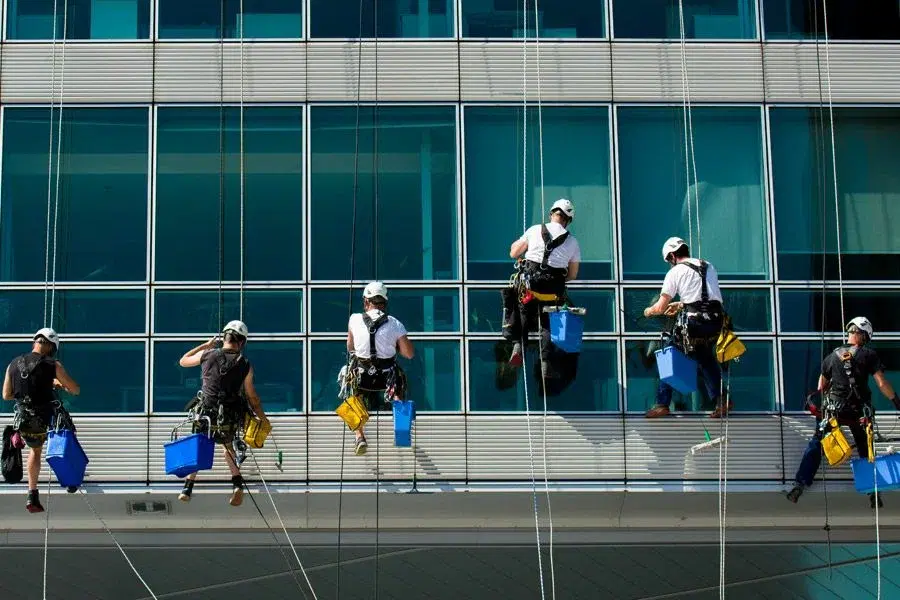 Professional window cleaner working on commercial glazing in Denver